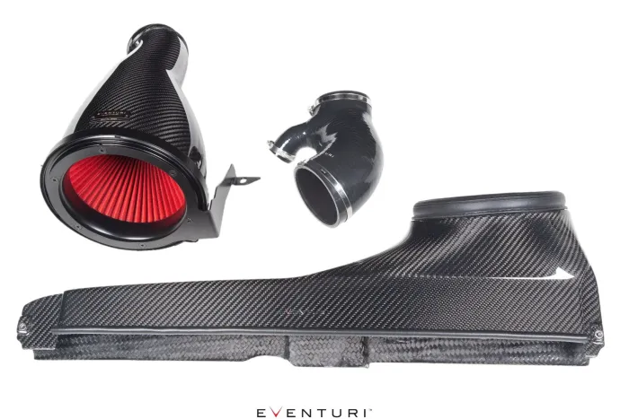 Carbon fiber air intake components resting on a white background, featuring red filters and black tubing. Text reads "EVENTURI."