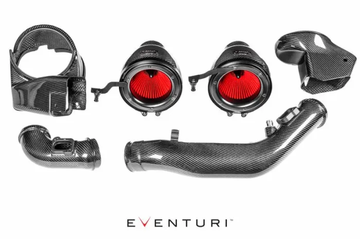 Carbon fiber automotive air intake kit with red filters displayed separately on a white background. Includes tubes, couplings, and housing components. Text reads "Eventuri" below the parts.