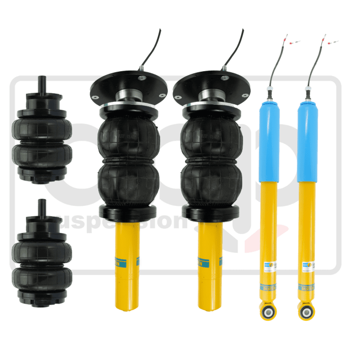 Suspension air springs and shock absorbers are arranged against a white background. The air springs are black and cylindrical, and the shock absorbers are yellow with blue tops. Some cables are visible.